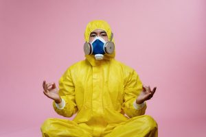 Person In Yellow Protective Suit Doing A Yoga Pose 3951367