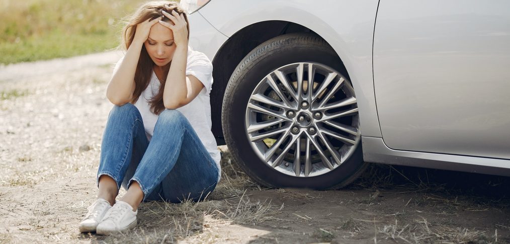 Worried Young Woman Sitting Near Broken Automobile At 4173090
