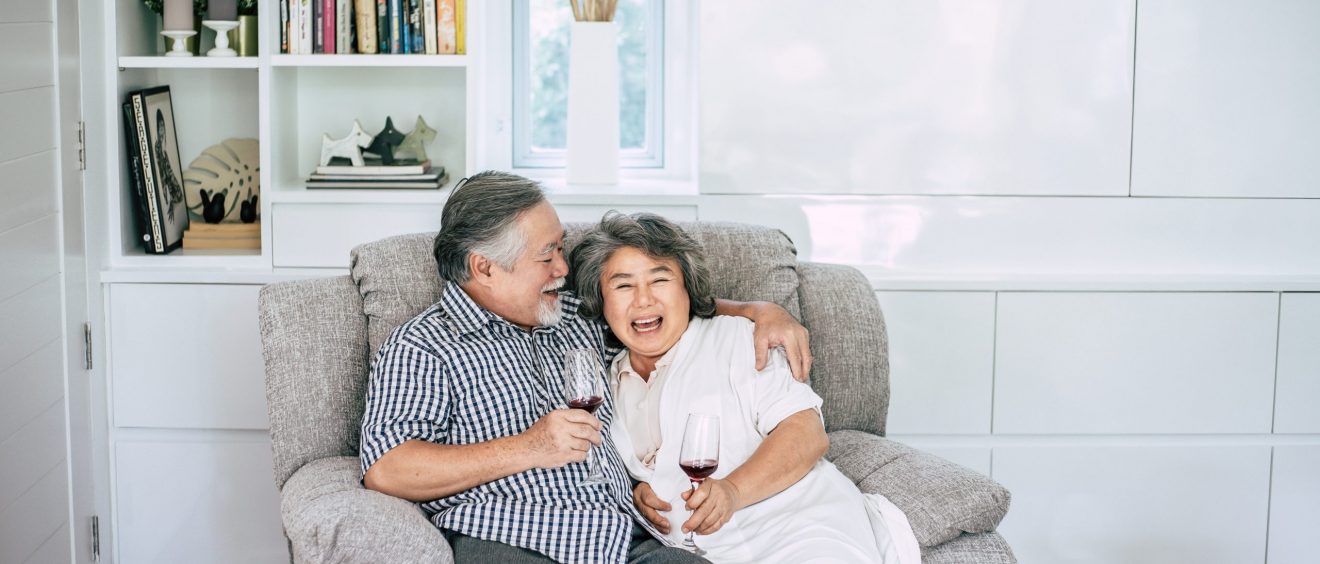 happy elderly woman and her husband drinking wine and happiness